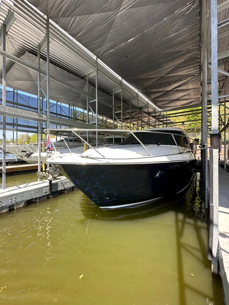 Slide: The Image of 2019 Tiara Yachts C53 docked in a covered marina. - 20