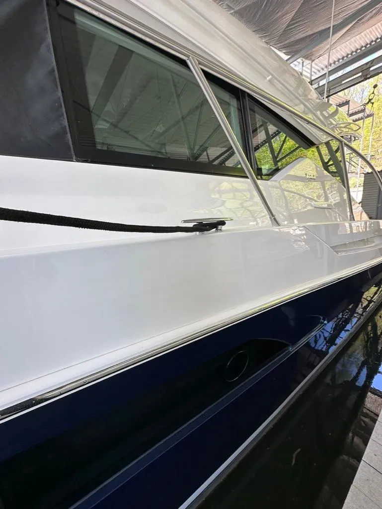 Slide: The Image of 2019 Tiara Yachts C53 model docked in a marina. - 21