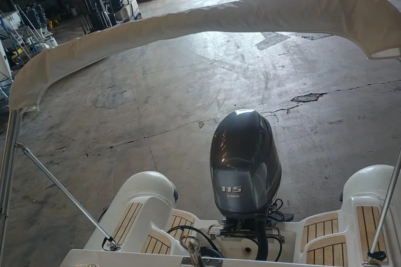Slide: The Image of 2014 AB Inflatables Nautilus 17 DLX with Yamaha 115 engine in a garage setting. - 10
