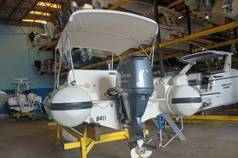 Slide: The Image of 2014 AB Inflatables Nautilus 17 DLX with Yamaha 115 engine in storage facility. - 15