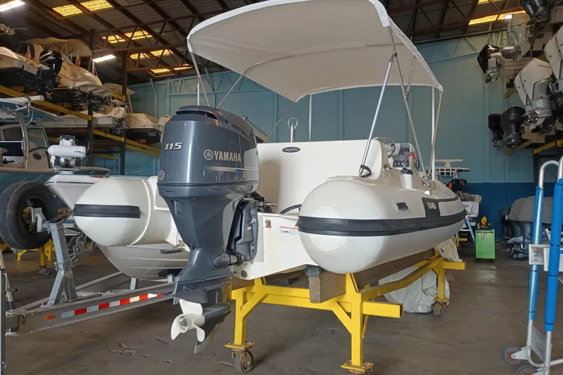 Slide: The Image of 2014 AB Inflatables Nautilus 17 DLX with Yamaha 115 engine in storage facility. - 16
