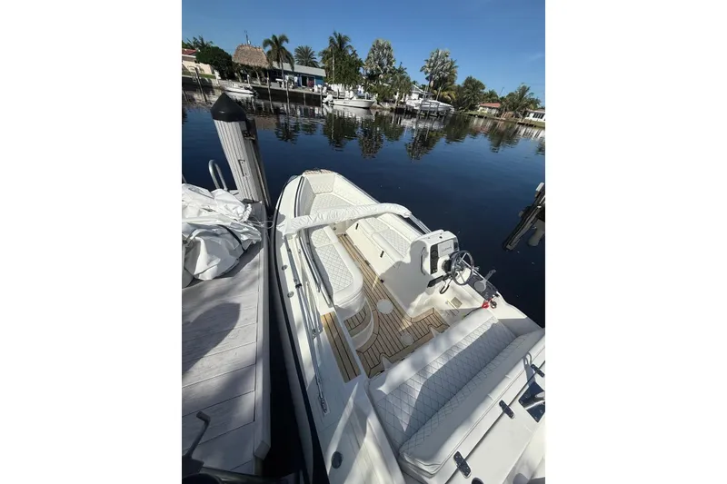 Slide: The Image of 2014 AB Inflatables Nautilus 17 DLX boat docked by a serene waterfront. - 18