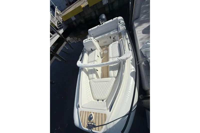 Slide: The Image of 2014 AB Inflatables Nautilus 17 DLX boat docked, featuring elegant seating and sleek design. - 19