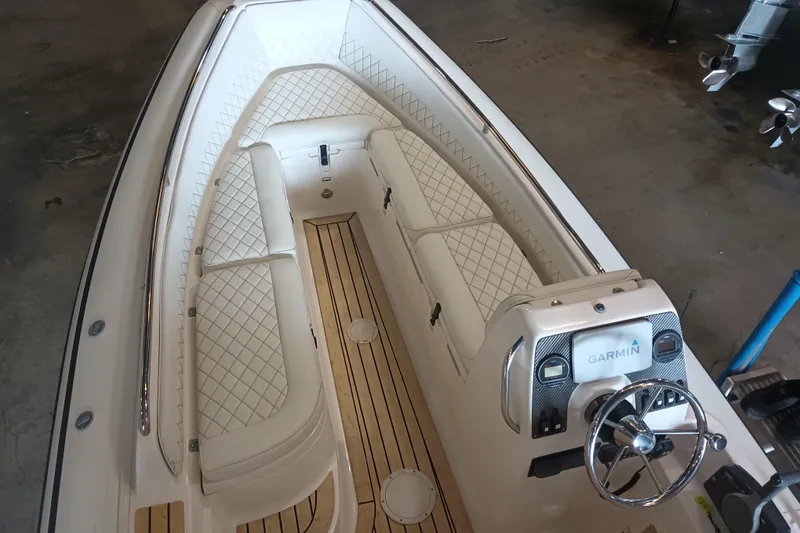 Slide: The Image of 2014 AB Inflatables Nautilus 17 DLX boat interior with Garmin navigation system and luxurious seating. - 2