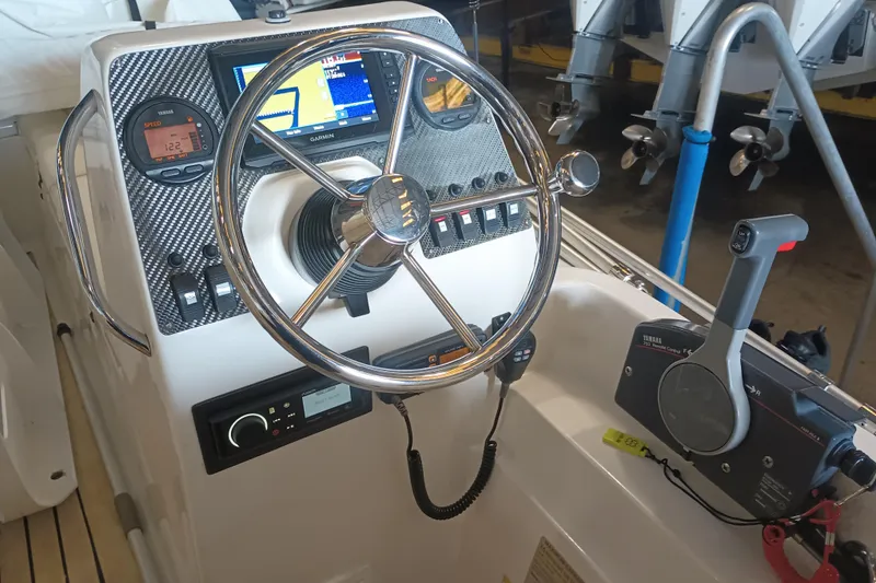 Slide: The Image of Control panel of 2014 AB Inflatables Nautilus 17 DLX with steering wheel and navigation instruments. - 3