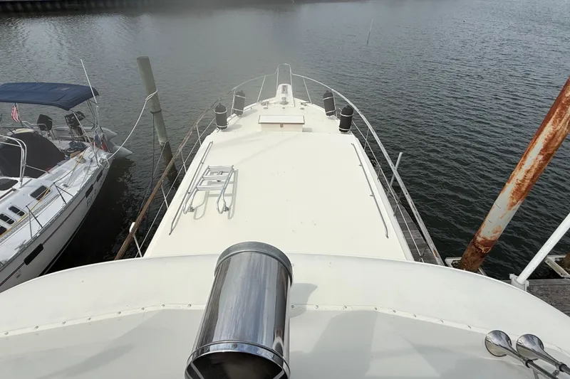Slide: The Image of 1981 Hatteras 43 Motor Yacht docked, view from the deck overlooking the water. - 16