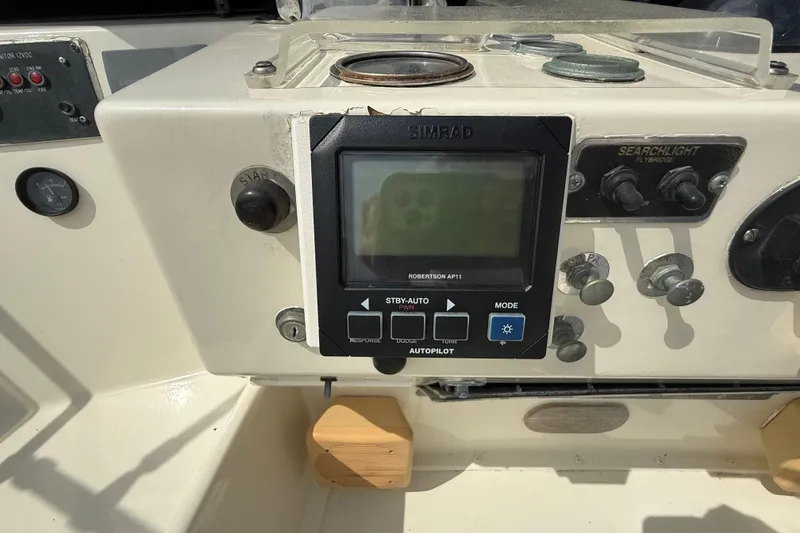 Slide: The Image of Control panel of a 1981 Hatteras 43 Motor Yacht with Simrad autopilot system. - 25