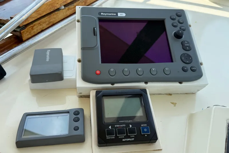 Slide: The Image of Navigation equipment on a 1981 Hatteras 43 Motor Yacht, featuring Raymarine and Simrad devices. - 28