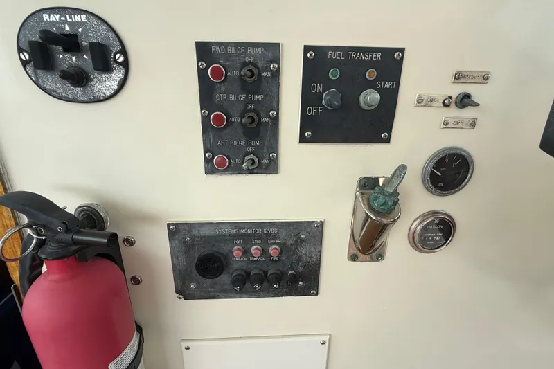 Slide: The Image of Control panel of a 1981 Hatteras 43 Motor Yacht with bilge pump switches and fire extinguisher. - 29