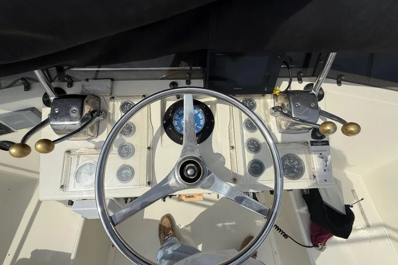 Slide: The Image of 1981 Hatteras 43 Motor Yacht helm with steering wheel and navigation instruments. - 34