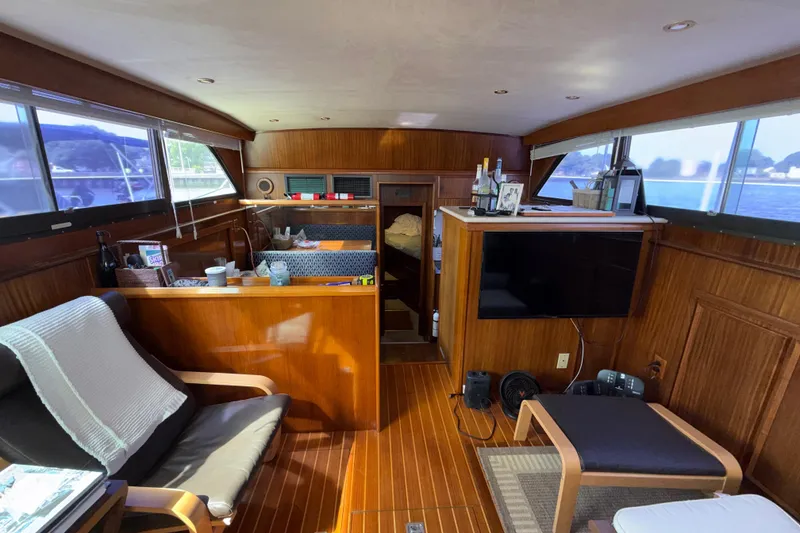 Slide: The Image of Interior of 1981 Hatteras 43 Motor Yacht with wood paneling and modern amenities. - 37