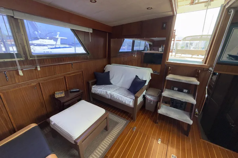 Slide: The Image of Interior of 1981 Hatteras 43 Motor Yacht with cozy seating and wooden decor. - 38