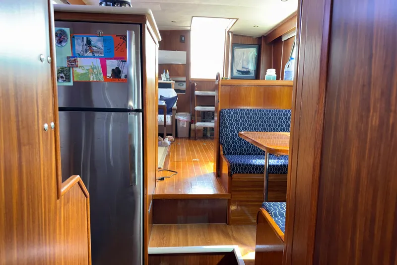 Slide: The Image of Interior of 1981 Hatteras 43 Motor Yacht with wood paneling and dining area. - 46
