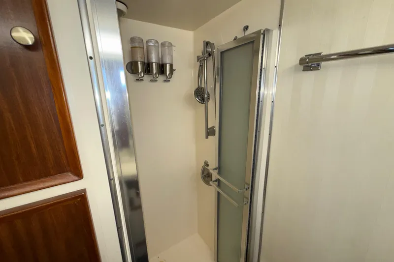 Slide: The Image of Shower area in 1981 Hatteras 43 Motor Yacht with modern fixtures and dispensers. - 52