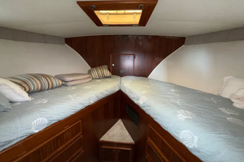 Slide: The Image of Interior cabin of 1981 Hatteras 43 Motor Yacht with twin beds and wooden paneling. - 54