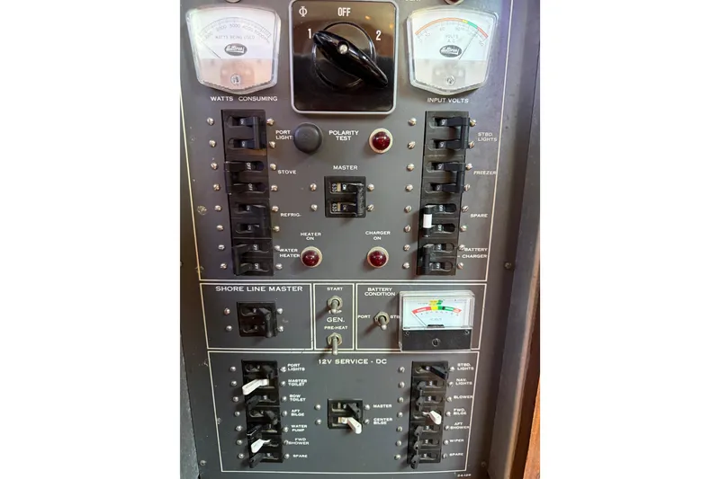 Slide: The Image of Electrical control panel of a 1981 Hatteras 43 Motor Yacht, featuring switches and meters. - 60