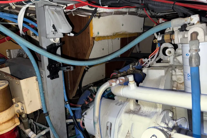 Slide: The Image of Engine room of a 1981 Hatteras 43 Motor Yacht with visible wiring and components. - 66