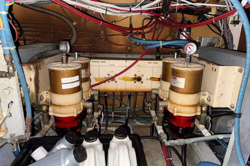 Slide: The Image of Engine room of a 1981 Hatteras 43 Motor Yacht with fuel filters and wiring. - 67