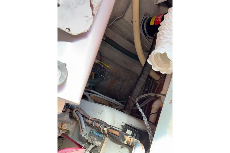 Slide: The Image of Engine compartment of a 1981 Hatteras 43 Motor Yacht with visible wiring and components. - 71