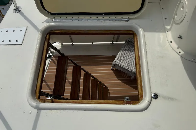 Slide: The Image of Hatch view of 1981 Hatteras 43 Motor Yacht with wooden stairs and deck. - 76