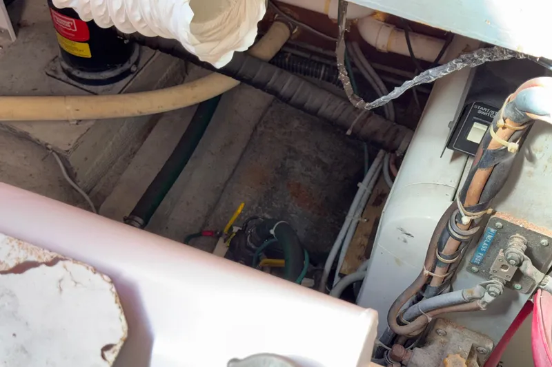 Slide: The Image of Engine room of a 1981 Hatteras 43 Motor Yacht with visible wiring and components. - 77