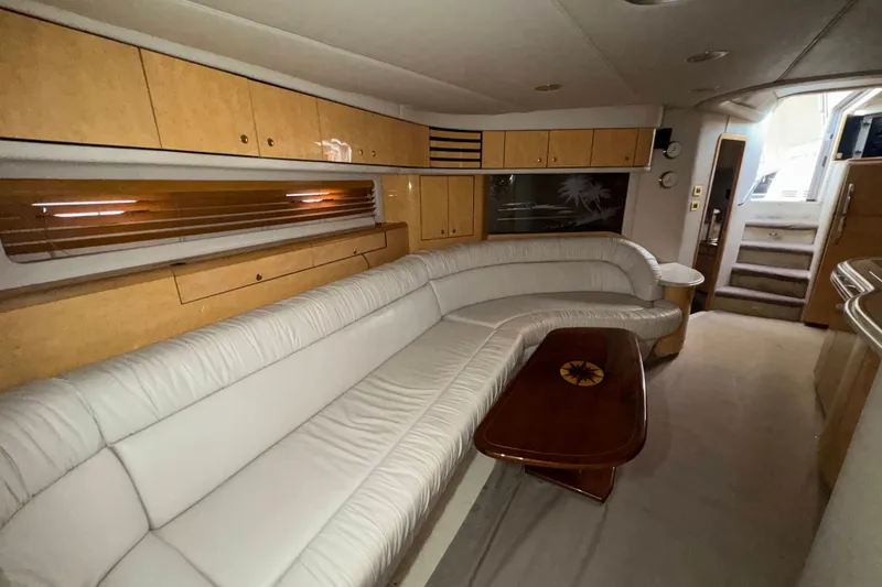 Slide: The Image of Luxurious interior of a 1998 Sea Ray Sundancer 540 yacht with plush seating and wooden accents. - 10