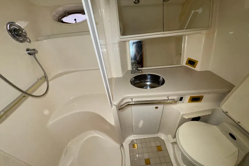 Slide: The Image of Bathroom interior of 1998 Sea Ray Sundancer 540 yacht, featuring shower, sink, and toilet. - 11