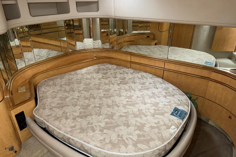 Slide: The Image of Luxurious cabin interior of 1998 Sea Ray Sundancer 540 with mirrored walls and floral mattress. - 12