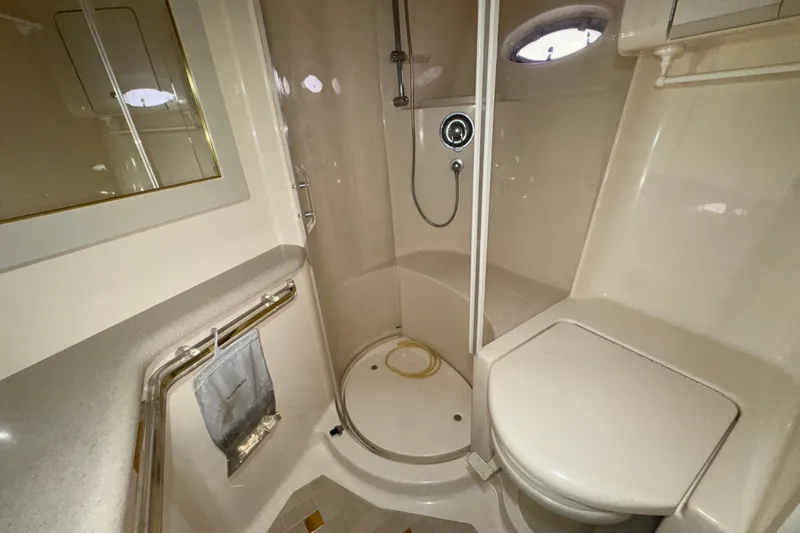 Slide: The Image of Bathroom interior of 1998 Sea Ray Sundancer 540 yacht, featuring shower and toilet. - 13