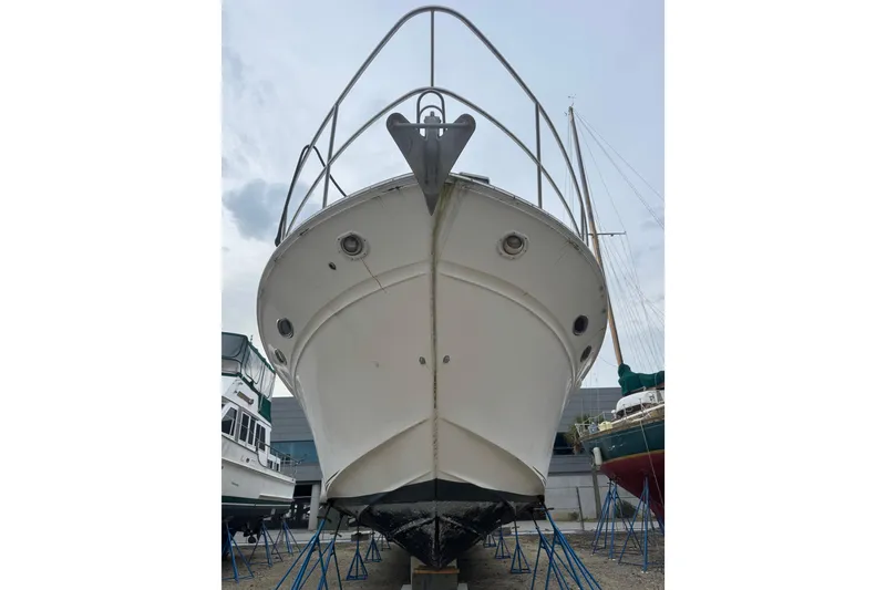 Slide: The Image of 1998 Sea Ray Sundancer 540 yacht on stands, viewed from the front, in a boatyard. - 4