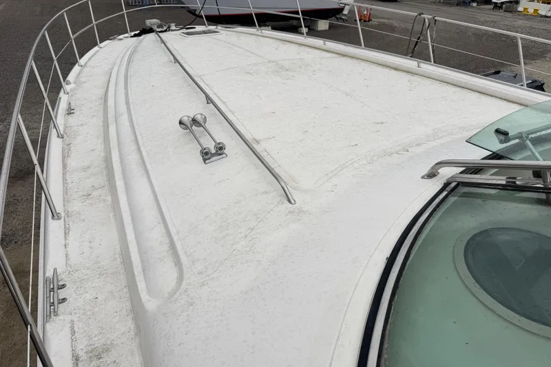 Slide: The Image of 1998 Sea Ray Sundancer 540 yacht deck with railing and windshield, docked at marina. - 7