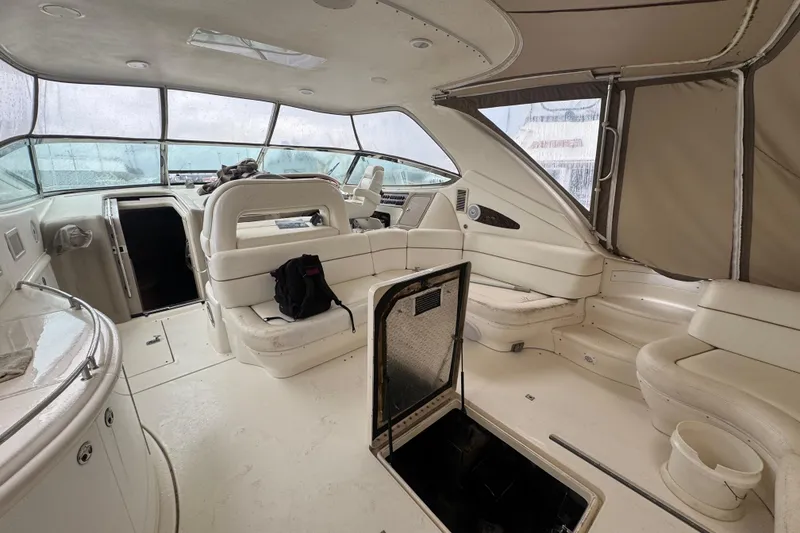 Slide: The Image of Spacious interior of 1998 Sea Ray Sundancer 540 yacht with white seating and open hatch. - 8