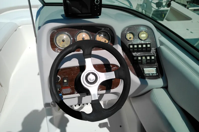 Slide: The Image of 2006 Chaparral 236 SSi boat dashboard with steering wheel and gauges. - 11