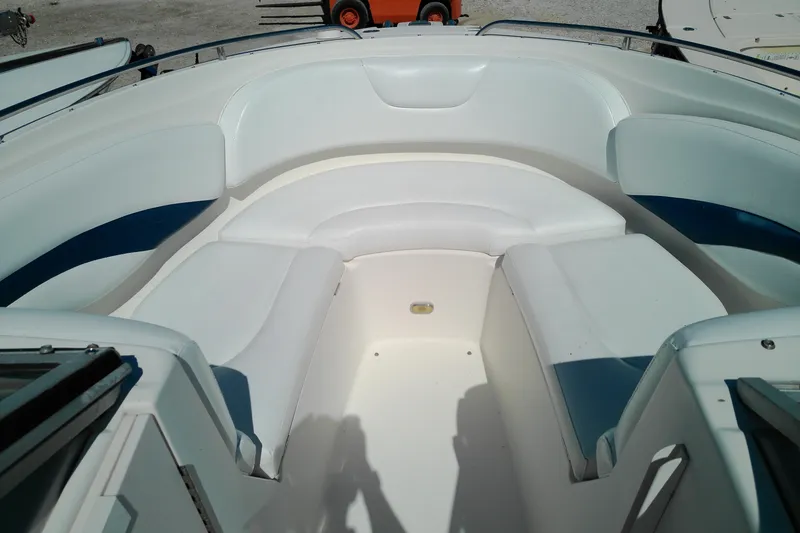 Slide: The Image of 2006 Chaparral 236 SSi boat interior with white and blue seating arrangement. - 12