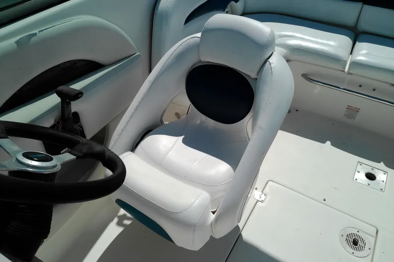 Slide: The Image of 2006 Chaparral 236 SSi boat interior with white captain's chair and steering wheel. - 14
