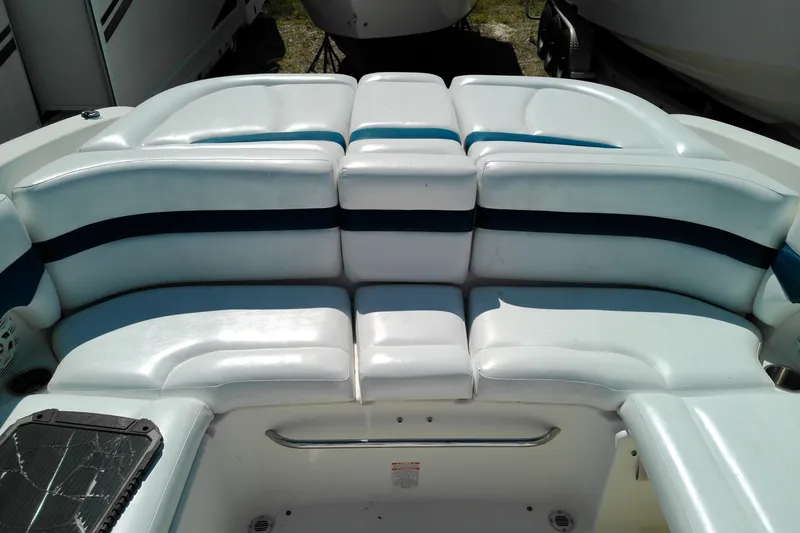 Slide: The Image of 2006 Chaparral 236 SSi boat interior with white and blue cushioned seating. - 15
