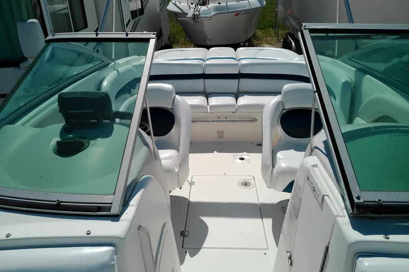 Slide: The Image of 2006 Chaparral 236 SSi boat interior with white seating and dual consoles. - 16