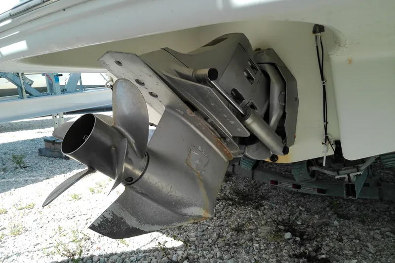 Slide: The Image of 2006 Chaparral 236 SSi boat propeller and outdrive on gravel surface. - 4