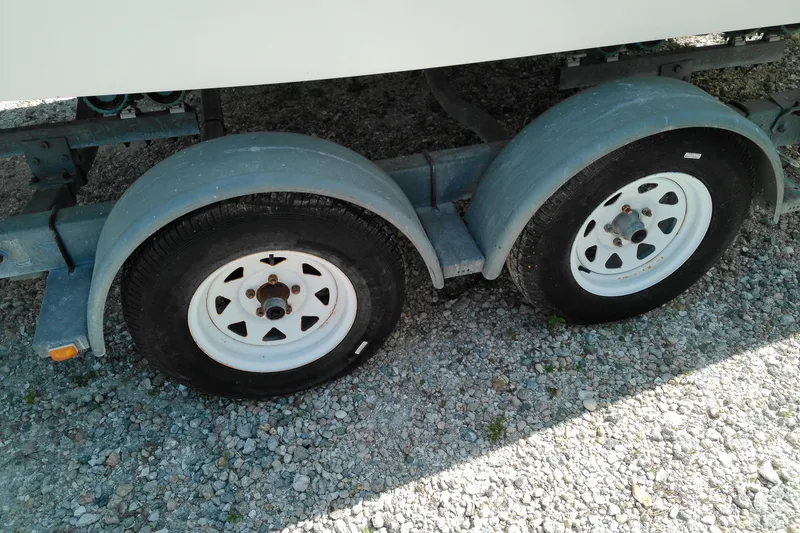 Slide: The Image of Trailer wheels for 2006 Chaparral 236 SSi boat on gravel surface. - 6