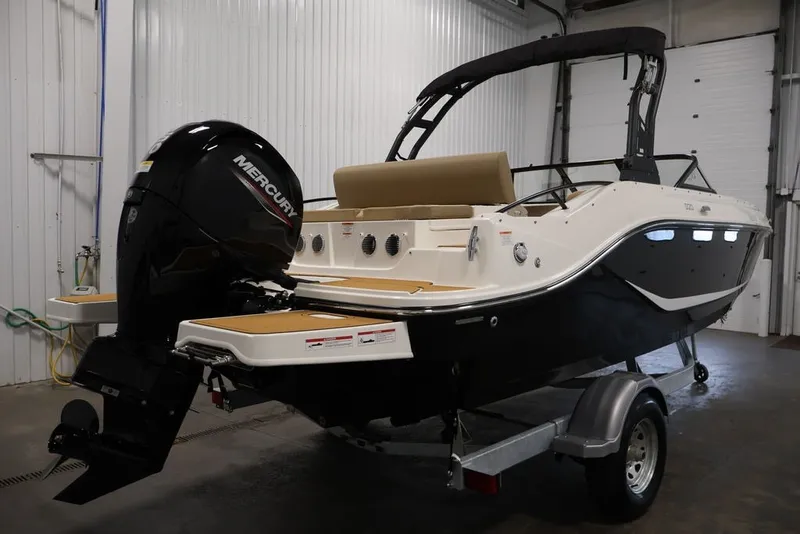 Slide: The Image of 2026 Bayliner D20 boat with Mercury engine in a garage setting. - 6