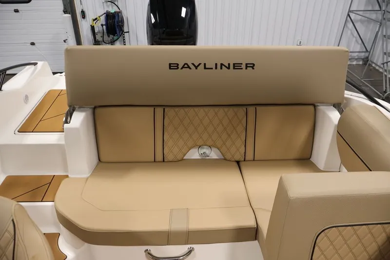 Slide: The Image of 2026 Bayliner D20 boat interior with beige seating and diamond stitching. - 24