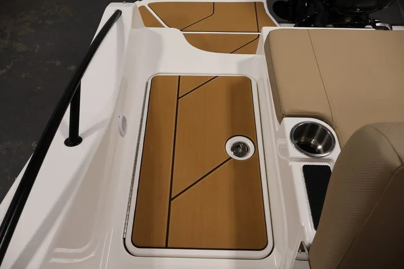 Slide: The Image of 2026 Bayliner D20 boat interior with teak flooring and cup holder. - 38