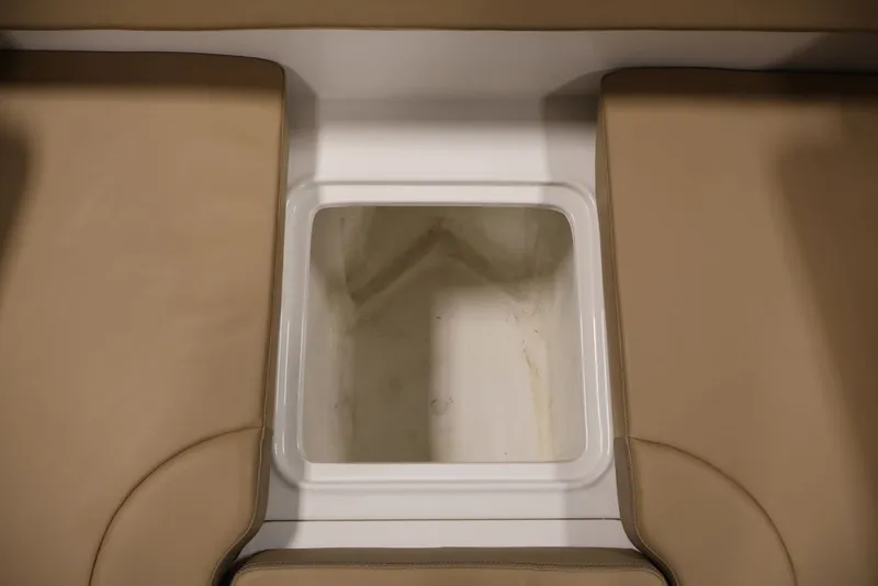 Slide: The Image of 2026 Bayliner D20 boat interior storage compartment with beige seating. - 12