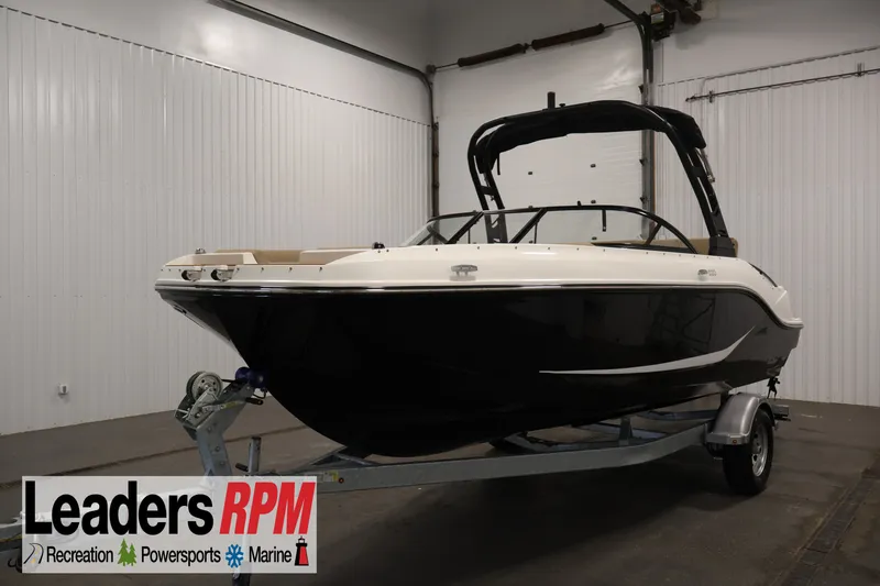 The Image of 2026 Bayliner D20 boat on trailer in indoor showroom setting. - 0