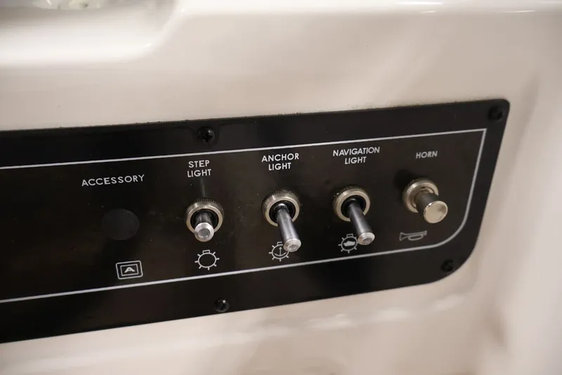 Slide: The Image of Control panel of 2026 Bayliner D20 boat with switches for lights and horn. - 17
