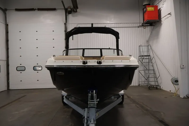 Slide: The Image of 2026 Bayliner D20 boat in a garage, front view on a trailer. - 2