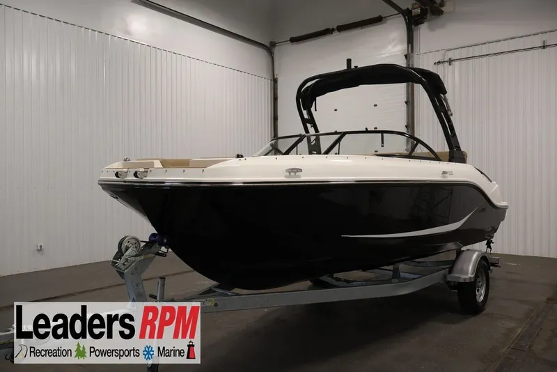 Slide: The Image of 2026 Bayliner D20 boat on trailer in indoor showroom. - 1