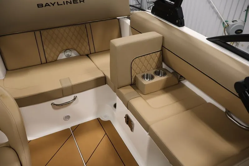 Slide: The Image of 2026 Bayliner D20 boat interior with tan seating and cup holders. - 30