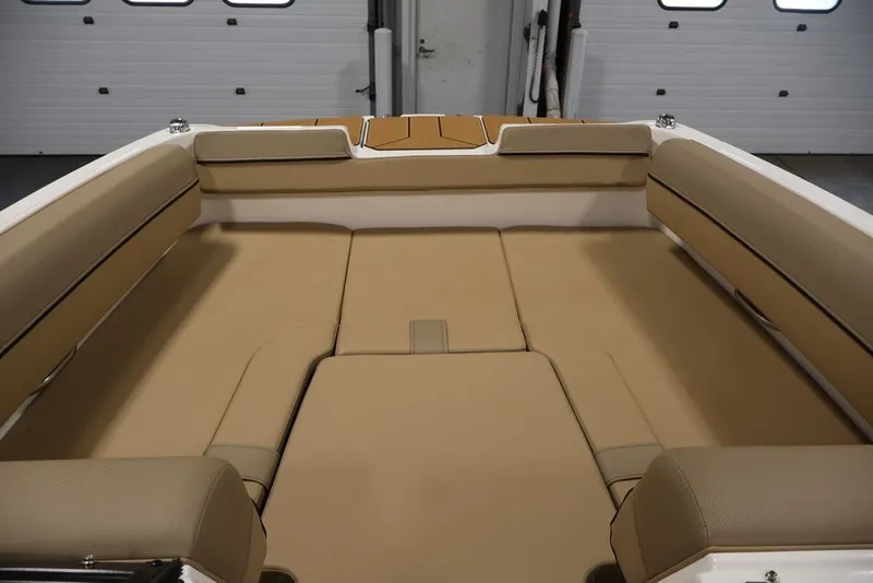 Slide: The Image of 2026 Bayliner D20 boat interior with beige cushioned seating and spacious layout. - 5