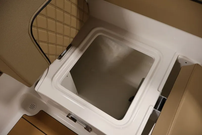 Slide: The Image of Interior storage compartment of 2026 Bayliner D20 boat with beige seating. - 27
